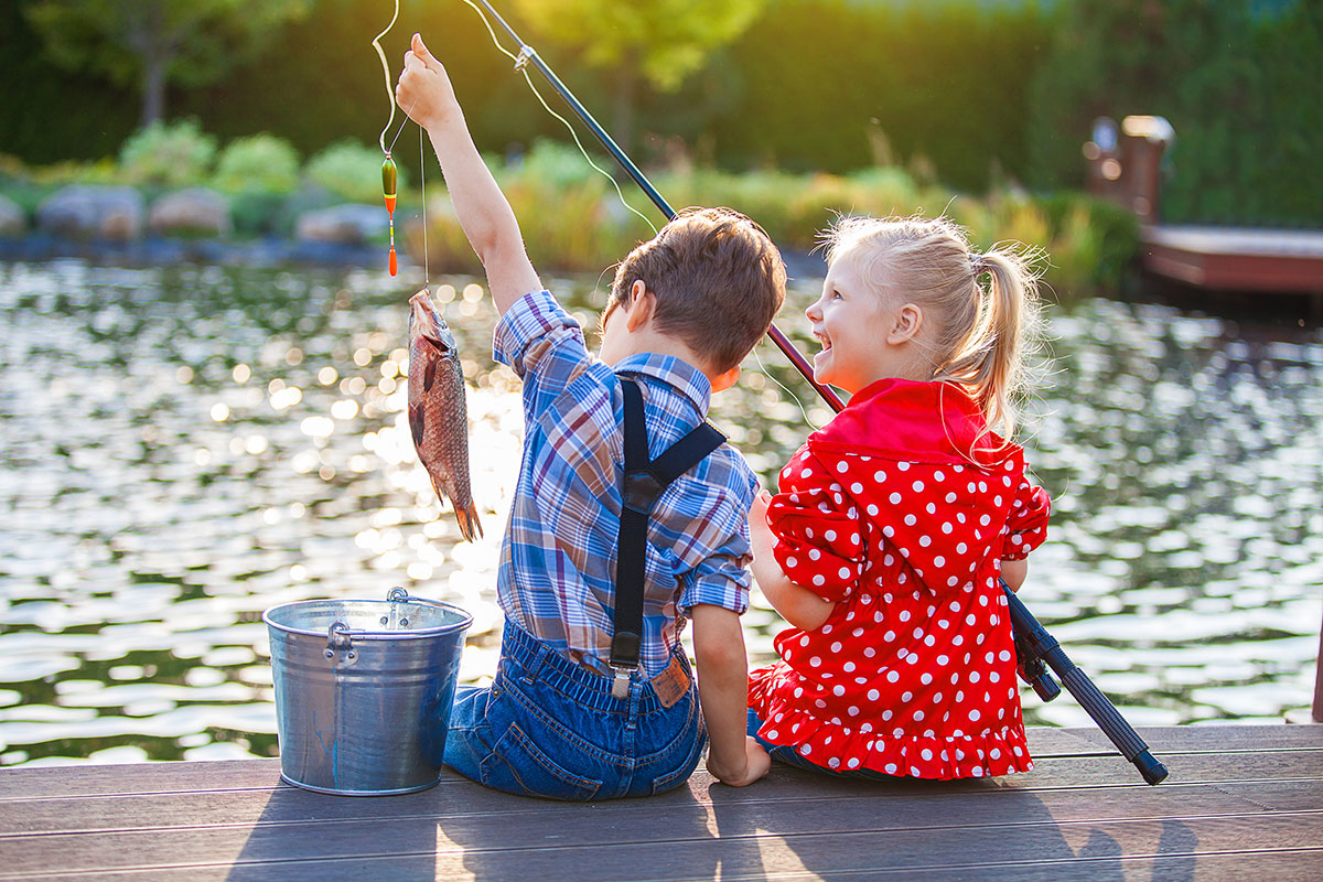 2 children fishing with poles and their catch